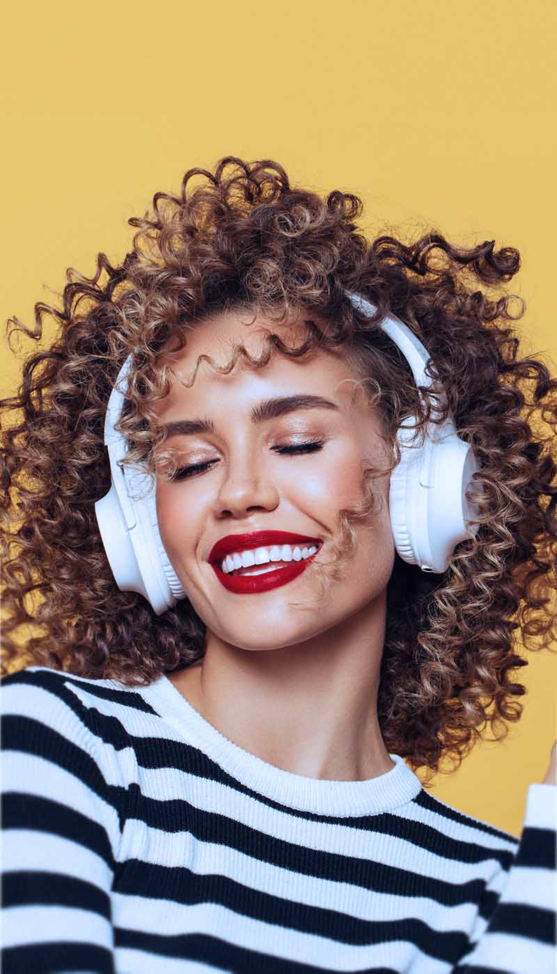 Woman wearing headphones listening to digital audio