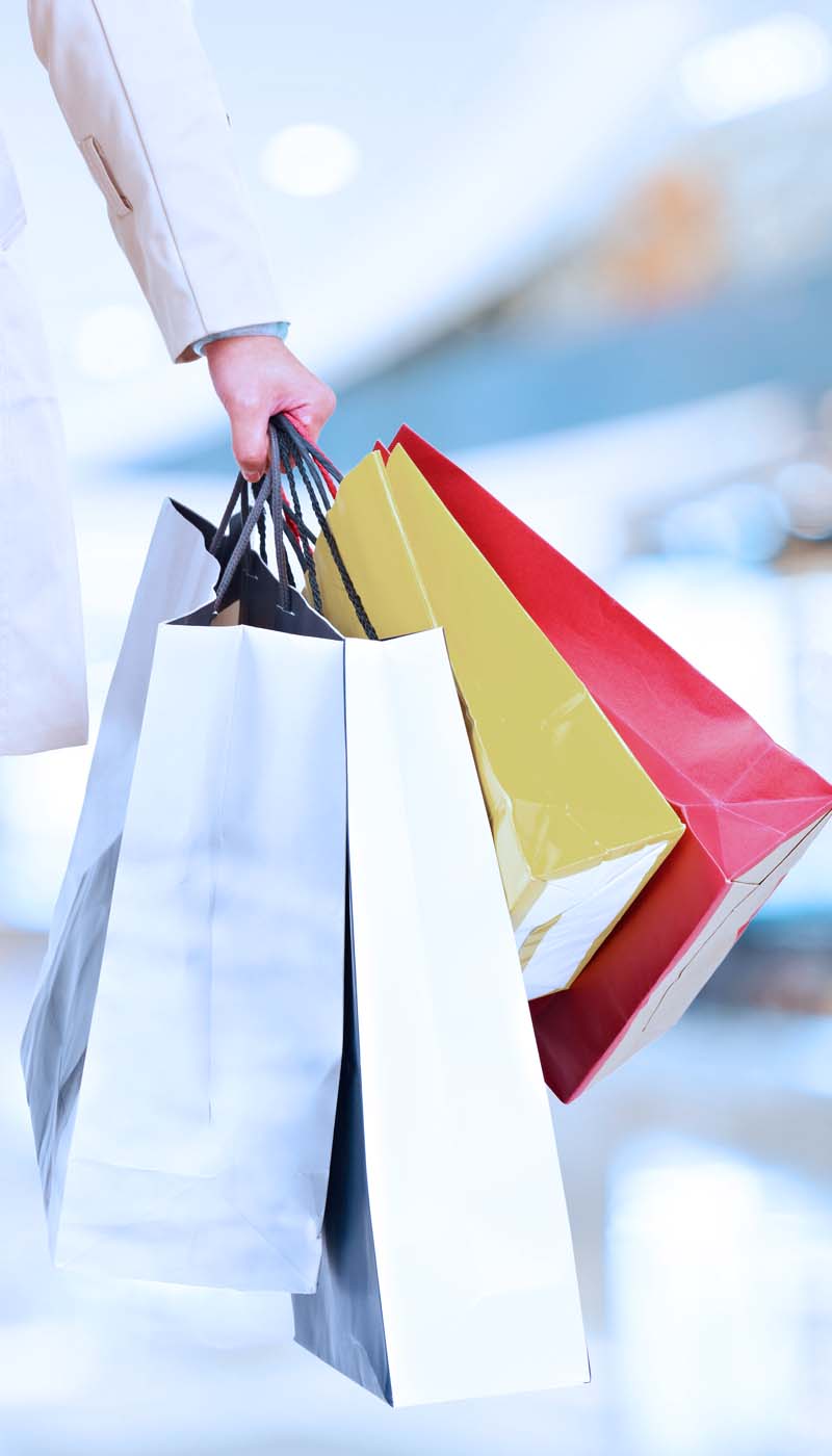 Woman holding many shopping bags
