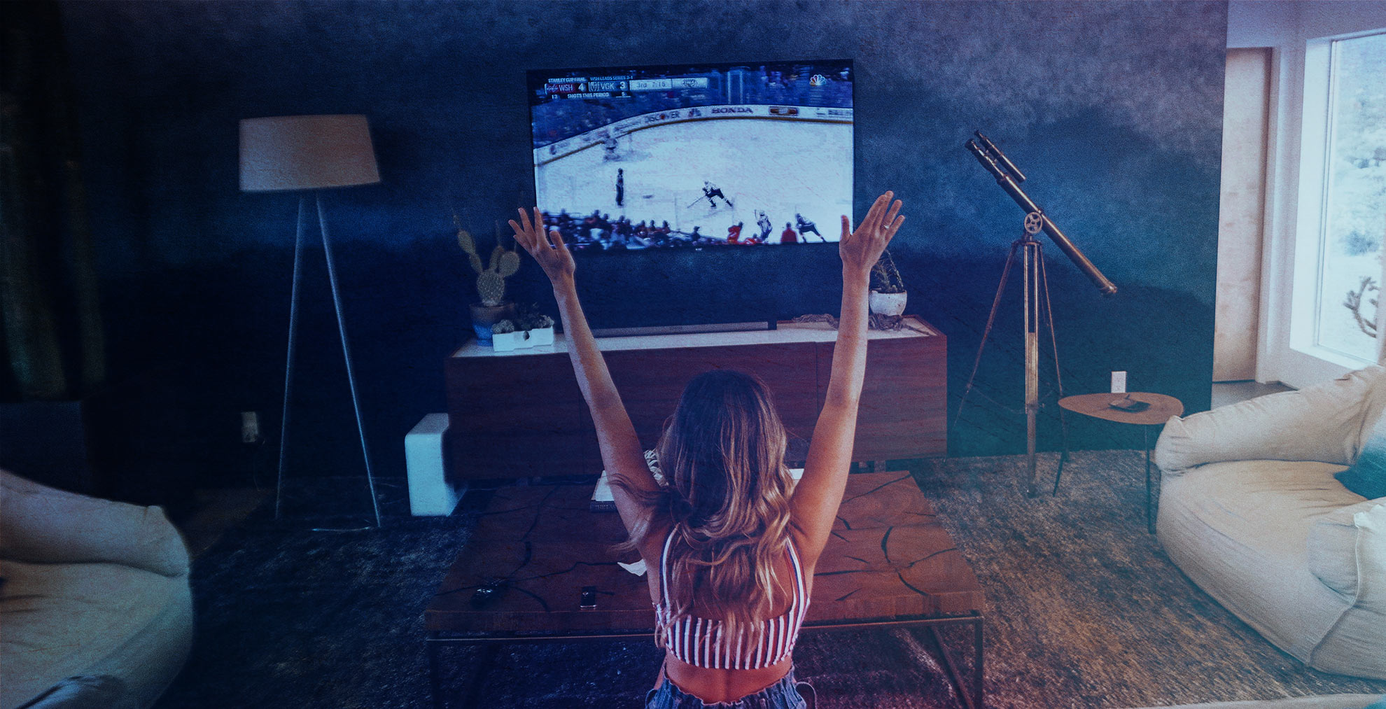 Woman watching live hockey on TV